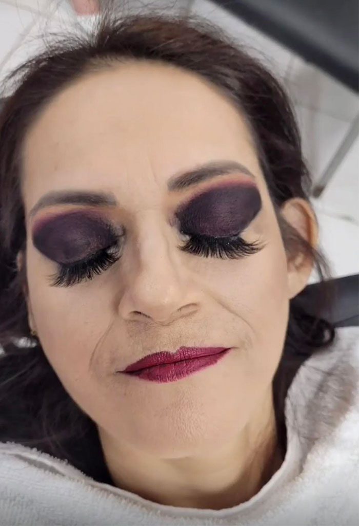 A person with dark makeup Description automatically generated