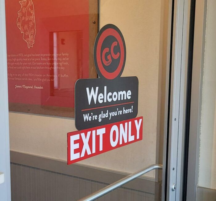 A sign on a glass door
Description automatically generated