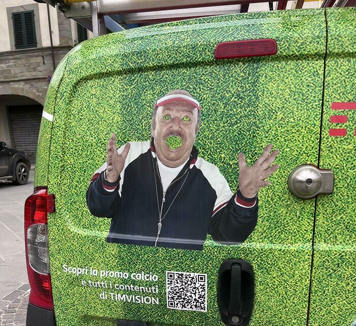 A van with a person on the side Description automatically generated